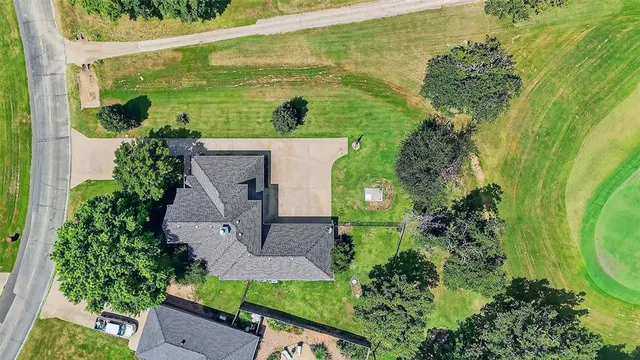 an aerial view of a house with a yard