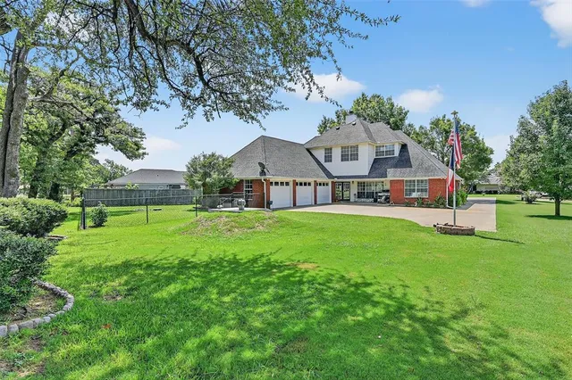 a front view of house with yard and green space