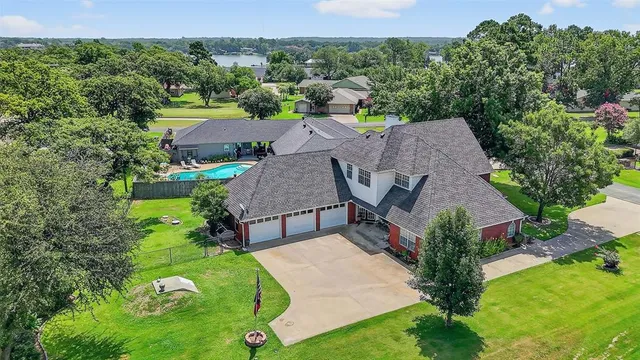 an aerial view of a house with garden space and street view