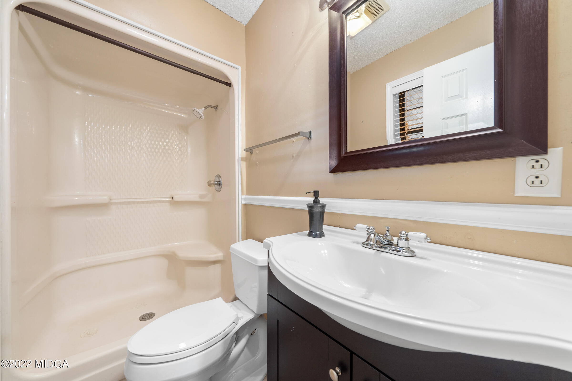457 Lite-N-Tie Road Gray, GA 31032 - Photo 14 of 30 a bathroom with a sink a toilet and shower