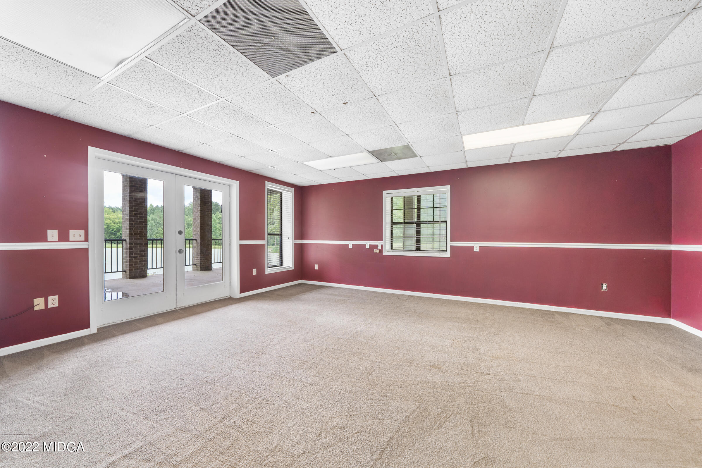 457 Lite-N-Tie Road Gray, GA 31032 - Photo 15 of 30 a view of an empty room with a fireplace and a window