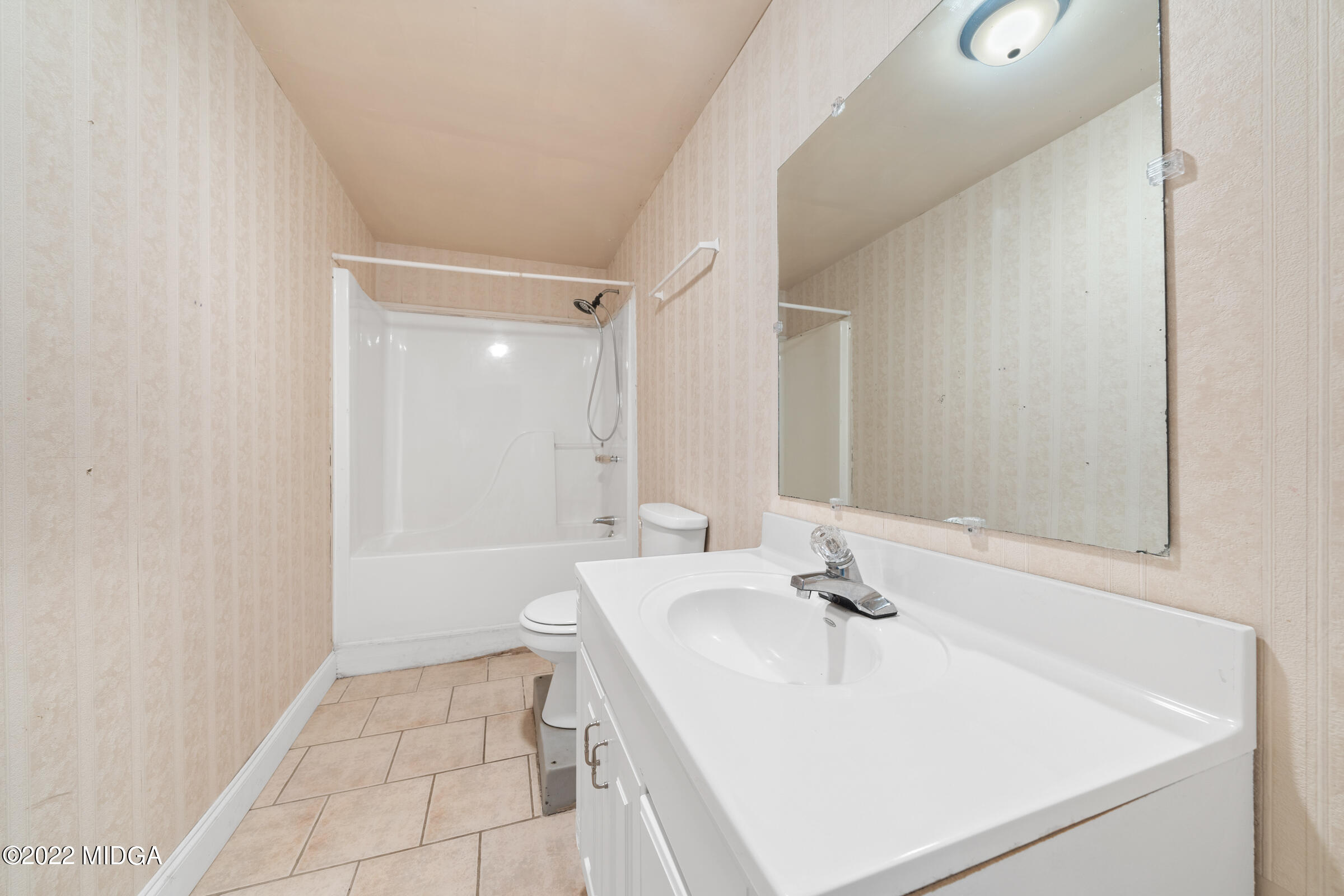 457 Lite-N-Tie Road Gray, GA 31032 - Photo 19 of 30 a bathroom with a sink a toilet and a mirror