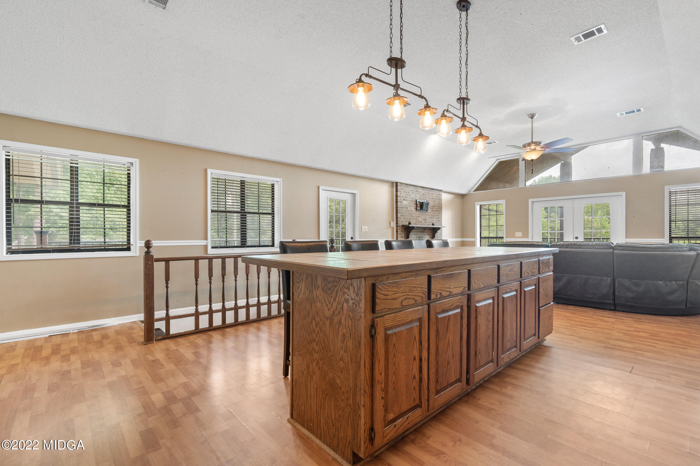 457 Lite-N-Tie Road Gray, GA 31032 - Photo 2 of 30 a view of a living room and kitchen with furniture wooden floor and windows