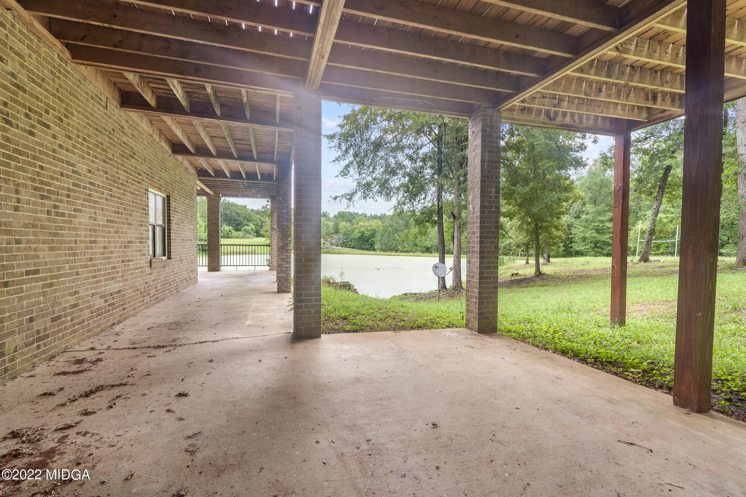 457 Lite-N-Tie Road Gray, GA 31032 - Photo 26 of 30 a view of a porch with a garden