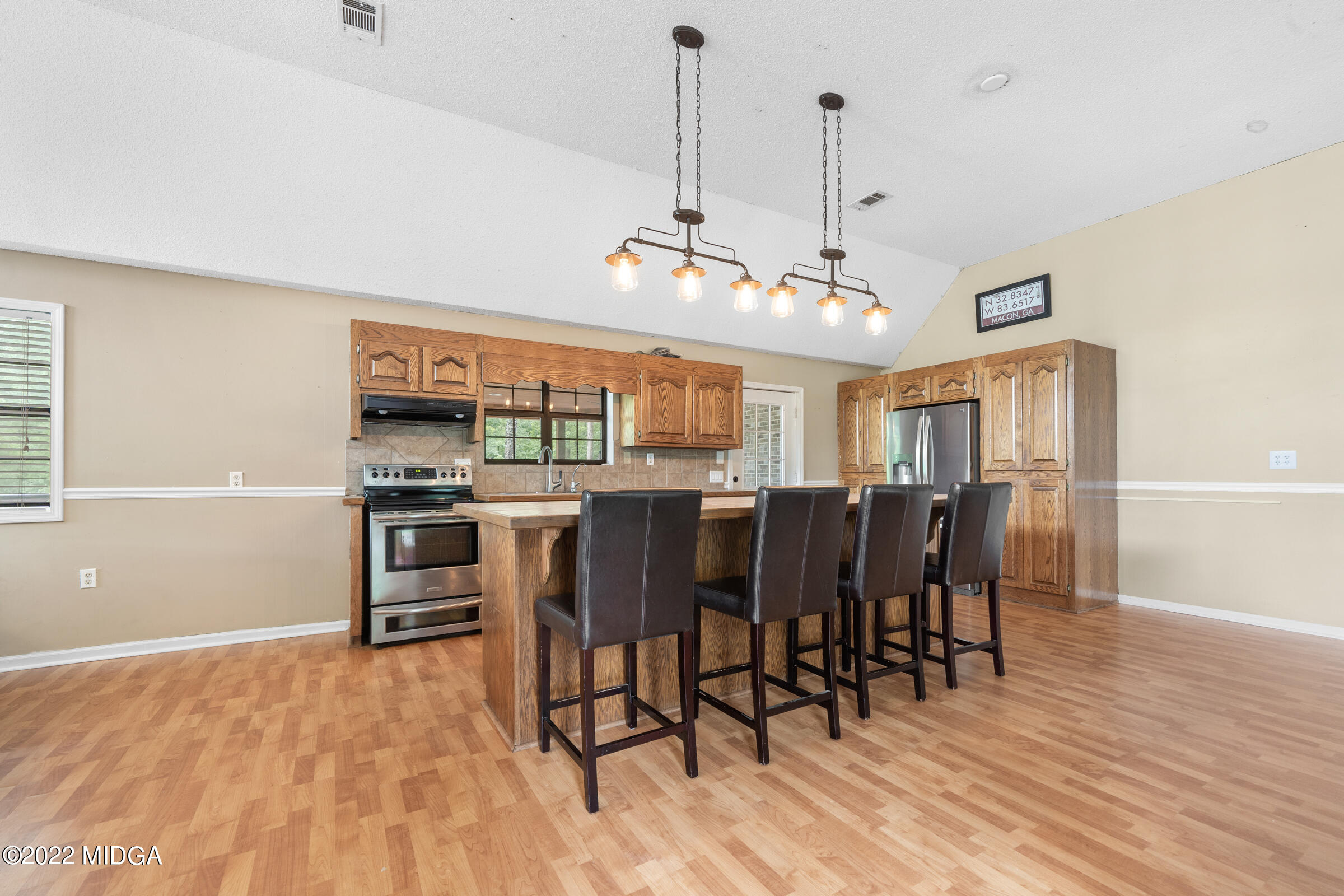 457 Lite-N-Tie Road Gray, GA 31032 - Photo 3 of 30 a view of a dining room with furniture and wooden floor
