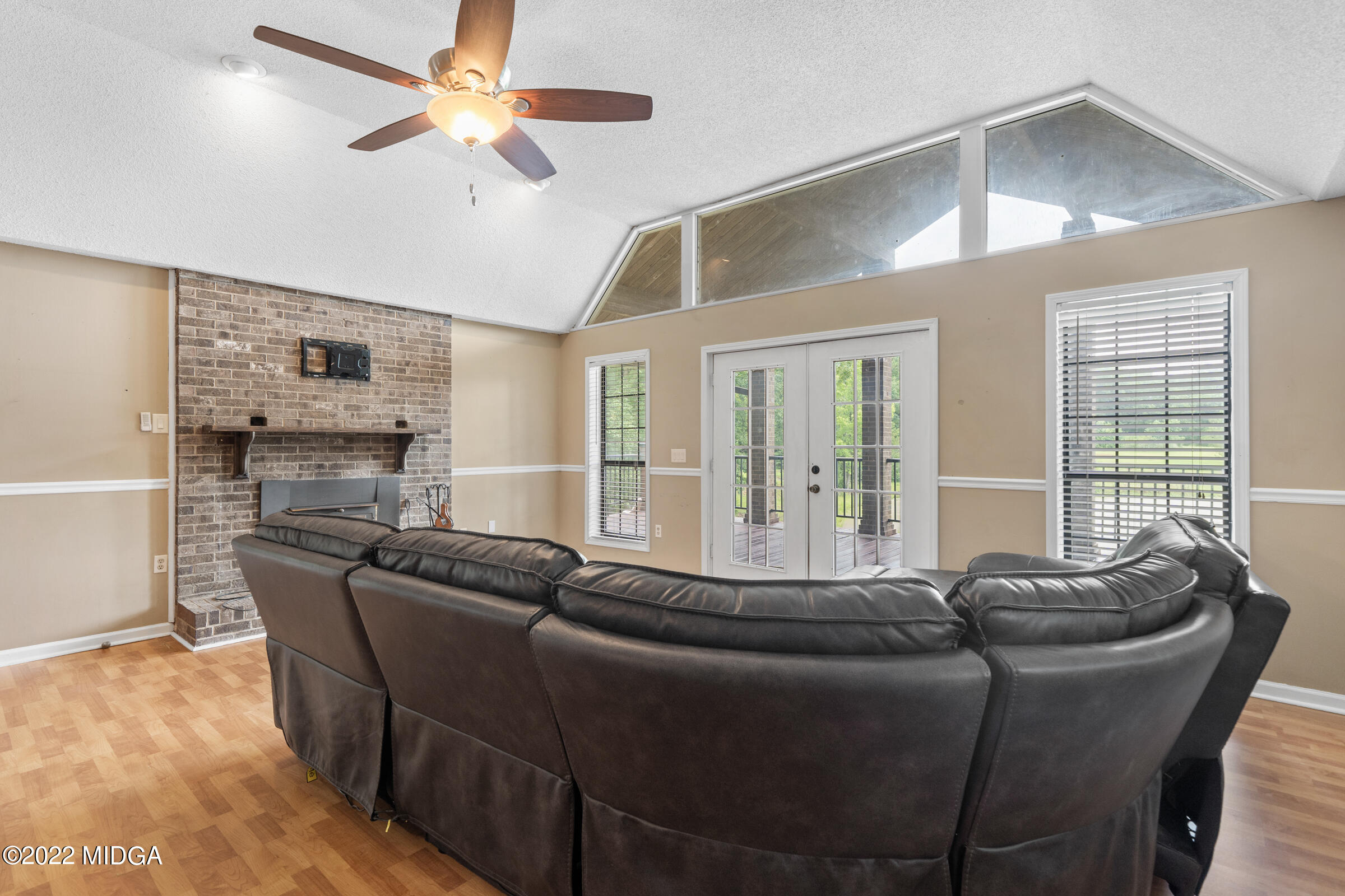 457 Lite-N-Tie Road Gray, GA 31032 - Photo 7 of 30 a living room with furniture and a fireplace