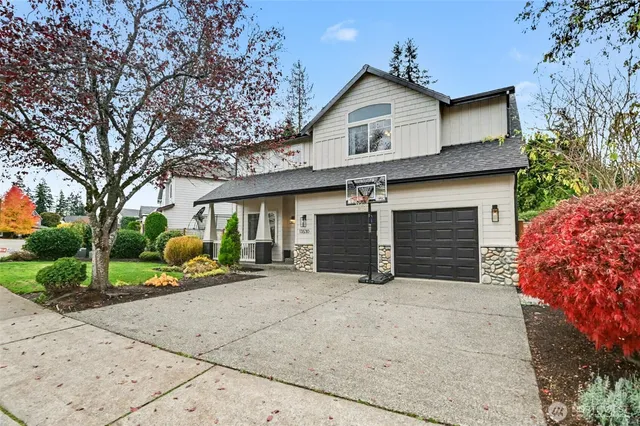 a front view of a house with a yard and garage