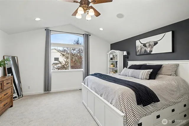 a bedroom with a large bed and a window