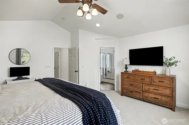 a bedroom with a bed and flat screen tv
