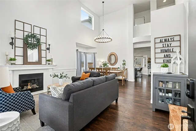 a living room with furniture a table and a clock