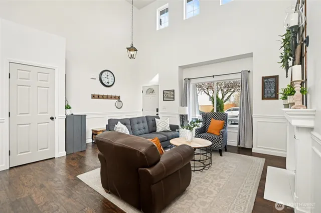 a living room with furniture and a clock