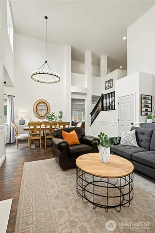 a living room with furniture a rug and white walls