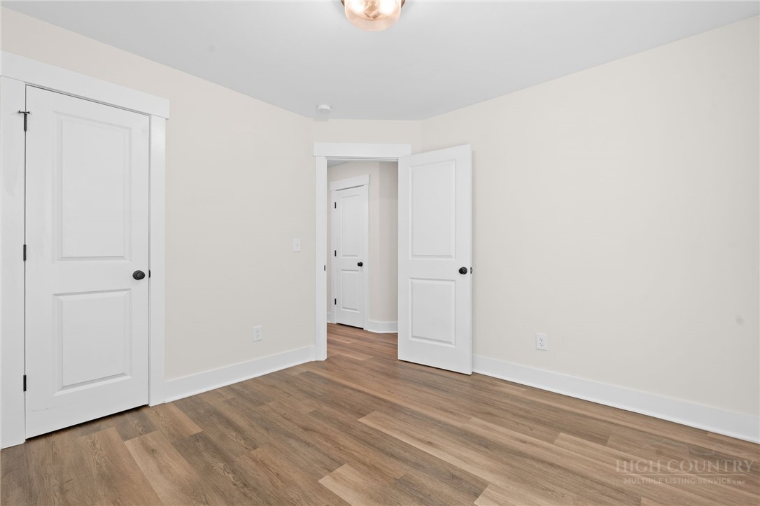228 Stratford Lane Boone, NC 28607 - Photo 26 of 33 a view of an empty room with wooden floor