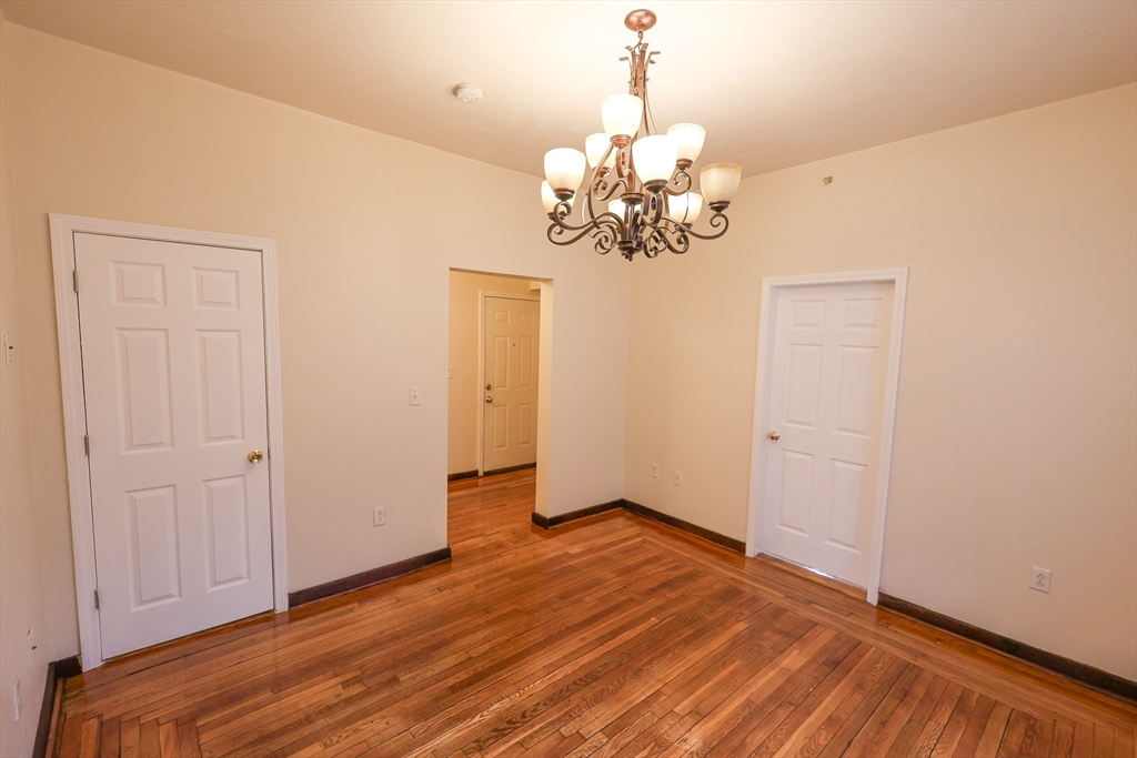 100 Seaver Street, Unit 2 Boston, MA 02121 - Photo 8 of 18 a view of an empty room with chandelier