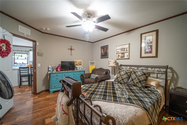 a bedroom with furniture and a wooden floor