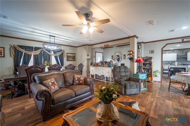 a living room filled with furniture and chandelier