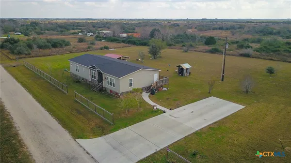 an aerial view of a house with a yard