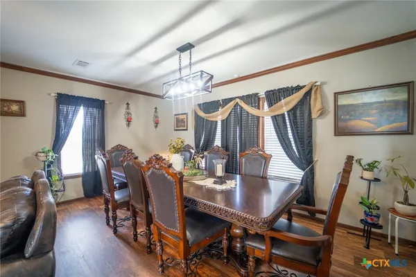 a view of a dining room with furniture and wooden floor
