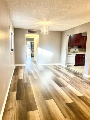 a view of a kitchen with a sink and cabinets