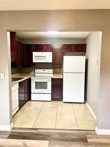 a kitchen with a stove a refrigerator and a sink