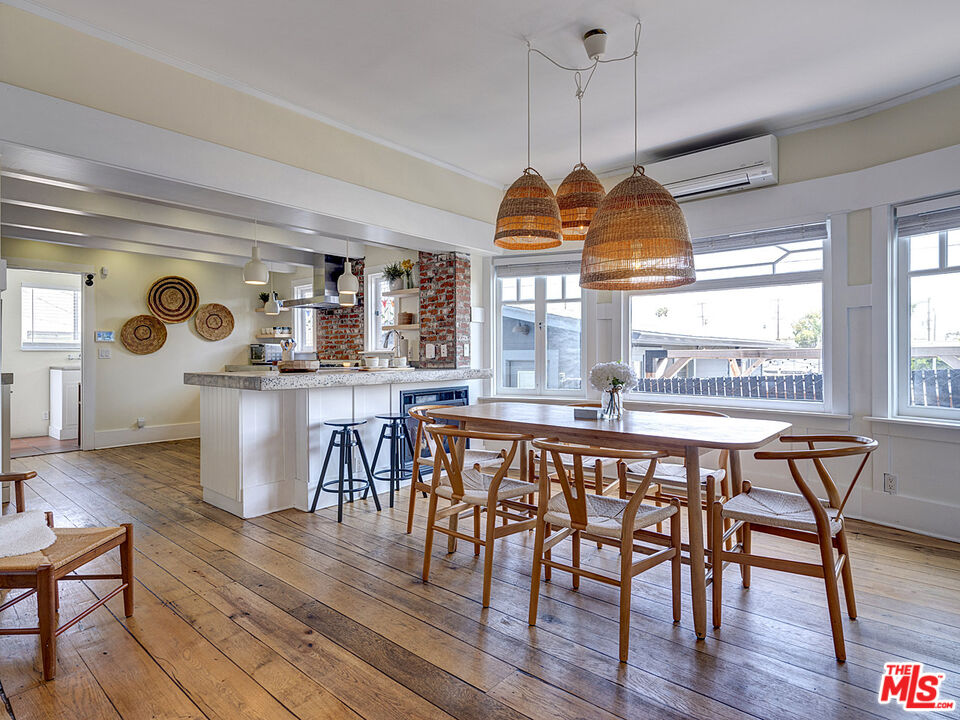 111 Dudley Avenue Venice, CA 90291 - Photo 12 of 33 a dining room with furniture a chandelier and wooden floor