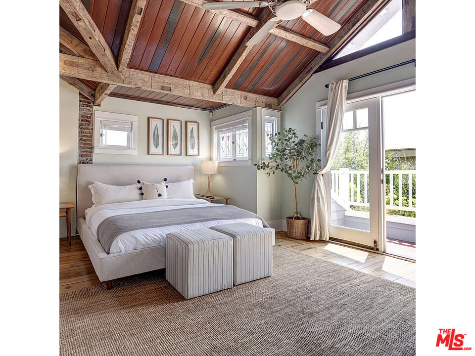 111 Dudley Avenue Venice, CA 90291 - Photo 20 of 33 a bedroom with a large bed and a chandelier