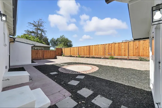 a view of backyard with swimming pool and outdoor seating