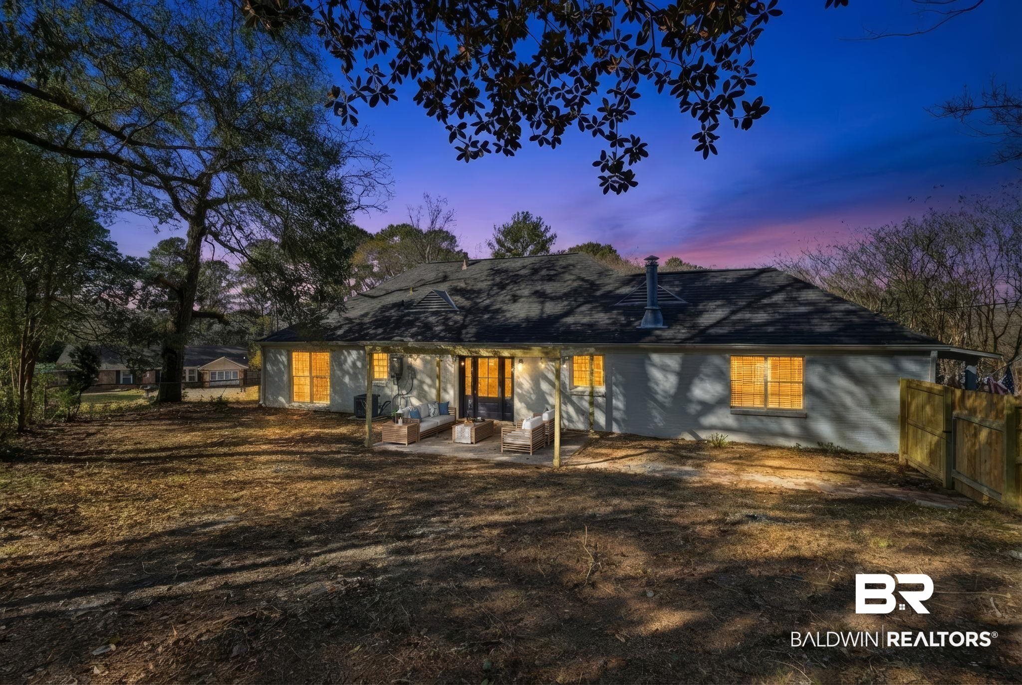 814 Nassau Drive Mobile, AL 36608 - Photo 44 of 44 Back of house at dusk featuring a patio