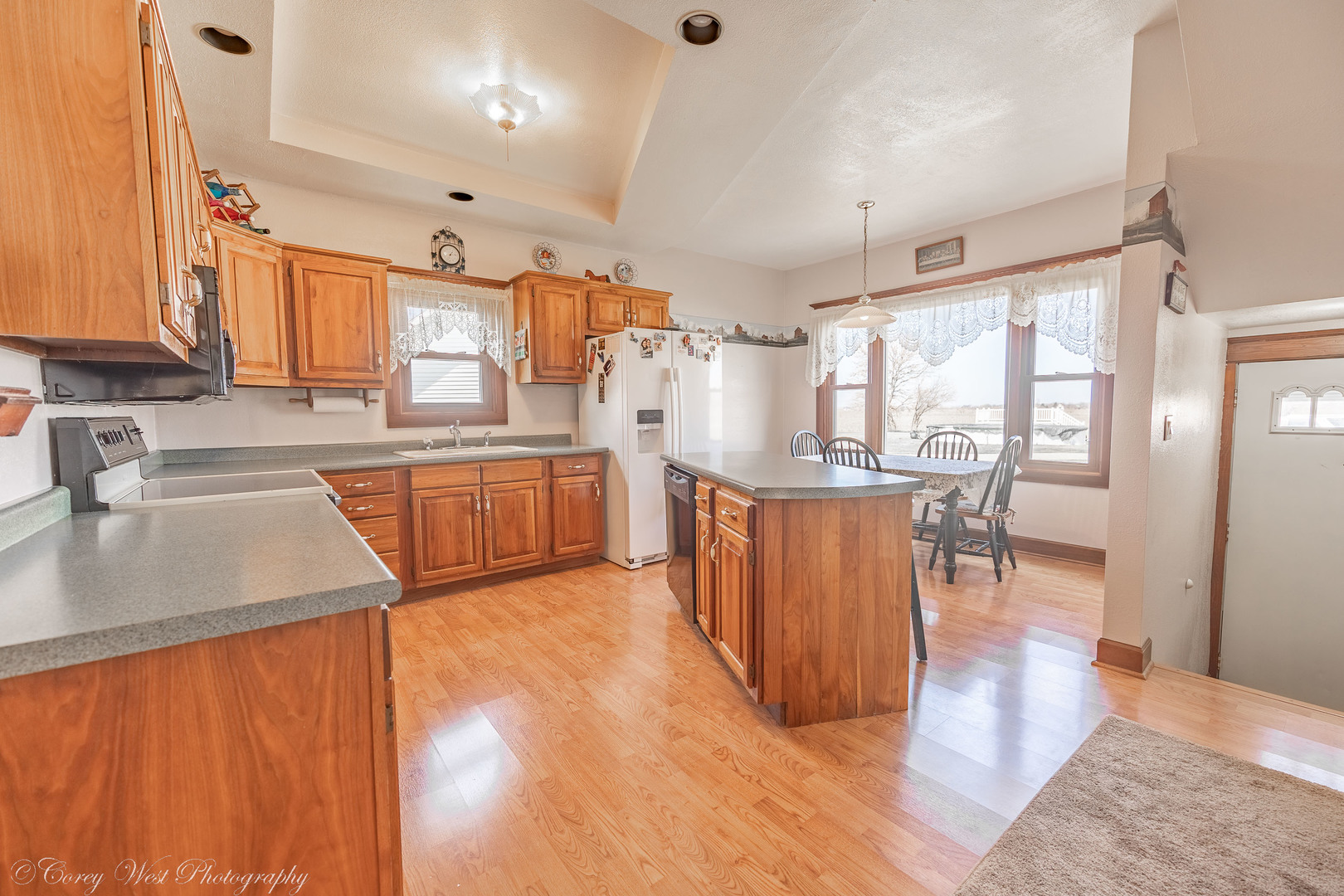 1137 Fisk Road Compton, IL 61318 - Photo 17 of 50 a kitchen with stainless steel appliances granite countertop a refrigerator a sink dishwasher a stove and a dining table with wooden floor