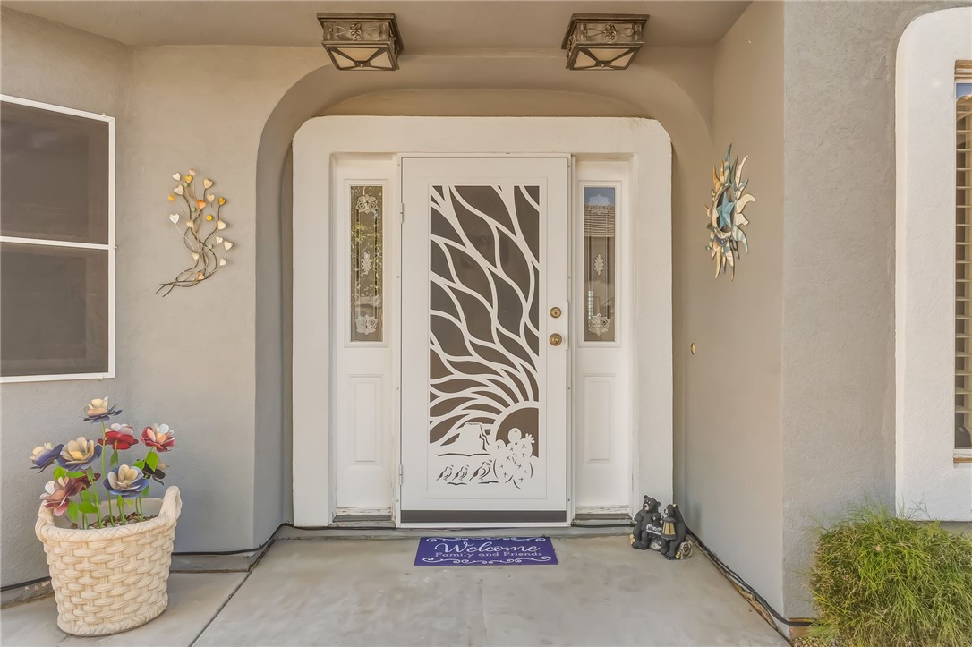 3342 Park Ridge Avenue Bullhead City, AZ 86429 - Photo 12 of 93 The property features a white front door with an intricate decorative screen and sidelight windows