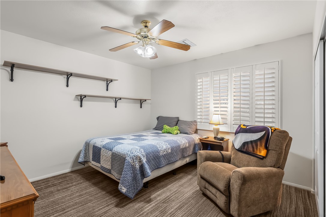 3342 Park Ridge Avenue Bullhead City, AZ 86429 - Photo 19 of 93 This room features wood-look flooring, a ceiling fan with integrated lighting, and window shutters