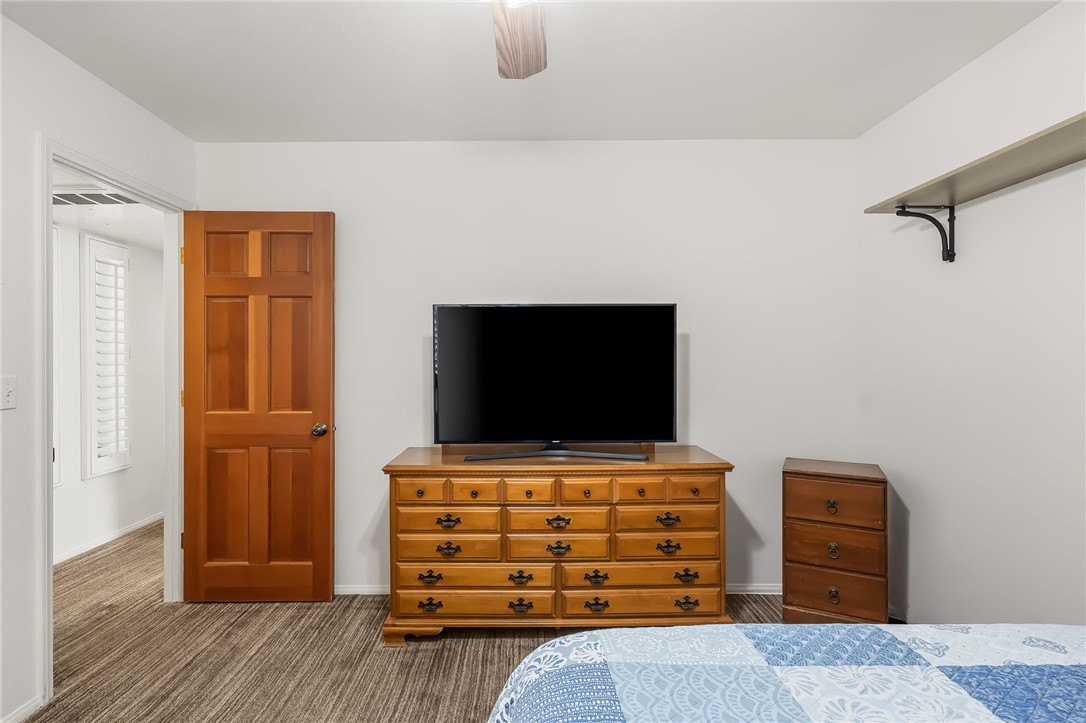3342 Park Ridge Avenue Bullhead City, AZ 86429 - Photo 20 of 93 This room features a paneled wooden door, a ceiling fan, and a shelf with metal supports