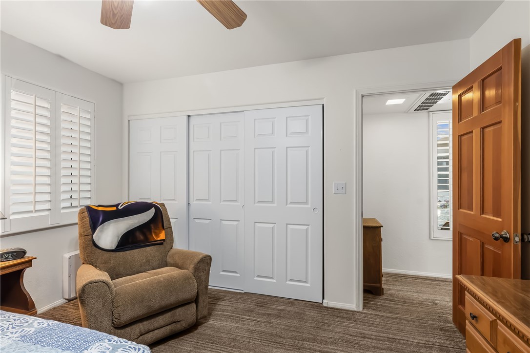 3342 Park Ridge Avenue Bullhead City, AZ 86429 - Photo 21 of 93 This room features a ceiling fan, white bi-fold closet doors, and window shutters
