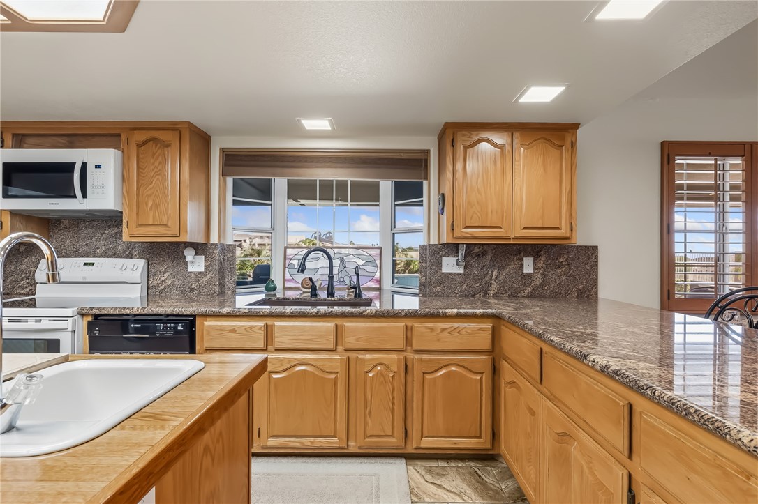 3342 Park Ridge Avenue Bullhead City, AZ 86429 - Photo 23 of 93 The kitchen features light wood cabinetry, granite countertops, and a double basin sink