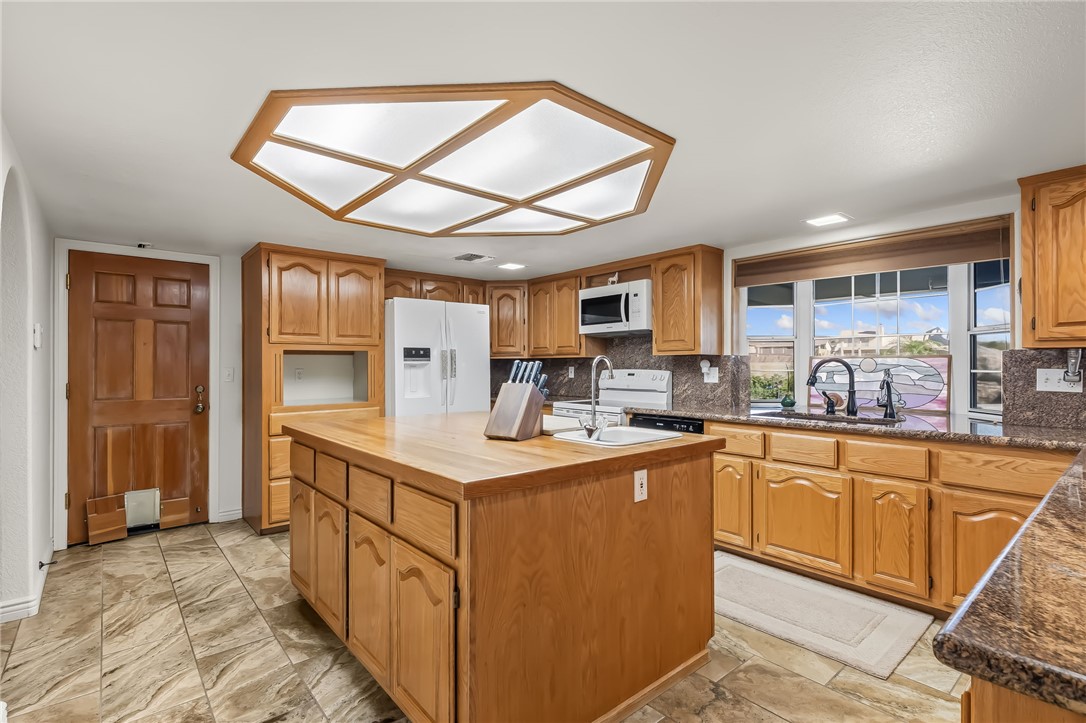 3342 Park Ridge Avenue Bullhead City, AZ 86429 - Photo 25 of 93 The kitchen features wood cabinetry, a central island with a wood countertop, and a window above the sink
