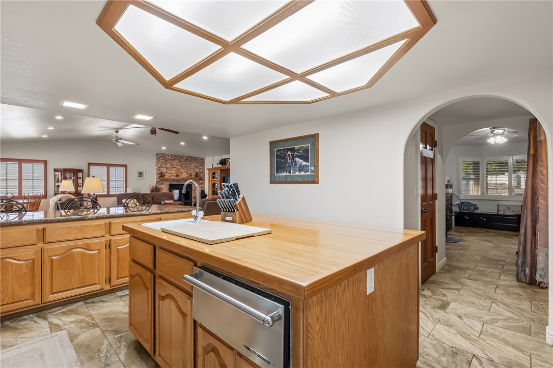 3342 Park Ridge Avenue Bullhead City, AZ 86429 - Photo 30 of 93 The kitchen features a central island with a sink and wood countertop, along with cabinetry with a wood finish