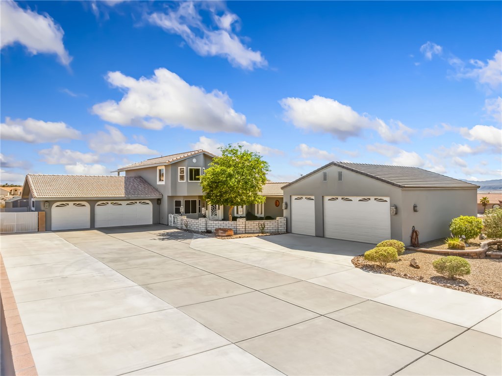 3342 Park Ridge Avenue Bullhead City, AZ 86429 - Photo 3 of 93 The property features an extensive concrete driveway, a main residence with an attached three-car garage, and a separate detached three-car garage, plenty of RV parking