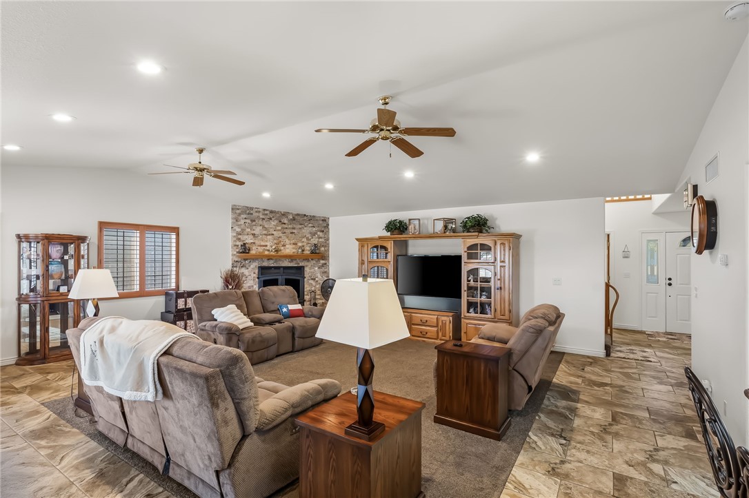 3342 Park Ridge Avenue Bullhead City, AZ 86429 - Photo 33 of 93 Spacious living area featuring a stone accent wall with a fireplace, recessed lighting, and ceiling fans