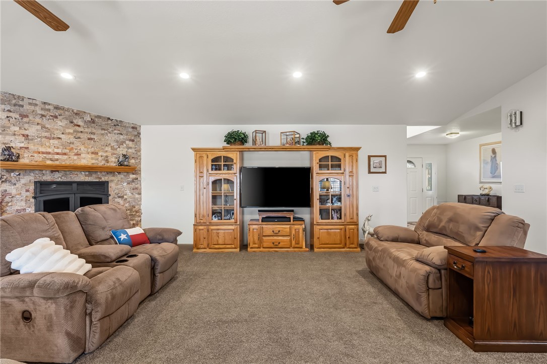 3342 Park Ridge Avenue Bullhead City, AZ 86429 - Photo 34 of 93 The living area features a brick accent wall with a fireplace, carpeted flooring, and recessed lighting