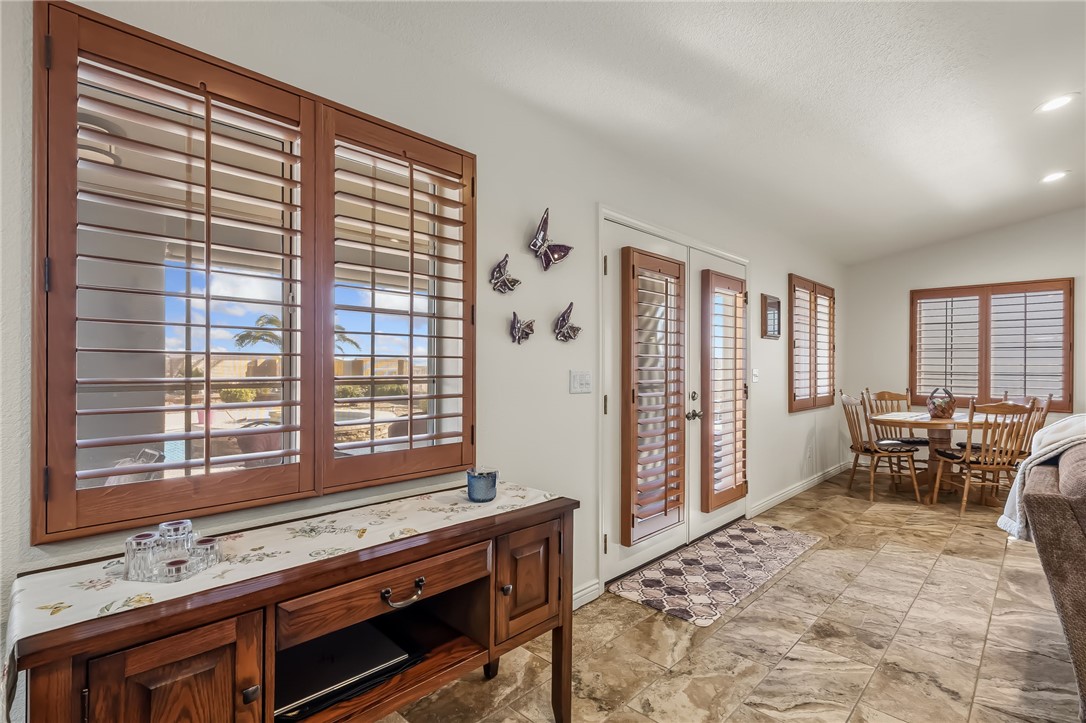 3342 Park Ridge Avenue Bullhead City, AZ 86429 - Photo 35 of 93 This living area features tile flooring, wooden window shutters, and a dining area with a round table and chairs