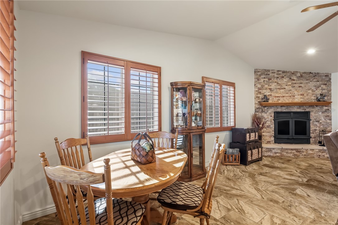 3342 Park Ridge Avenue Bullhead City, AZ 86429 - Photo 36 of 93 This inviting space features a corner fireplace with a stone surround and a wooden mantel, creating a focal point