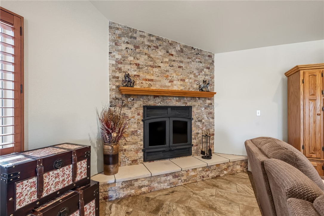 3342 Park Ridge Avenue Bullhead City, AZ 86429 - Photo 37 of 93 The living area features a stone-clad fireplace with a wooden mantel and a raised hearth