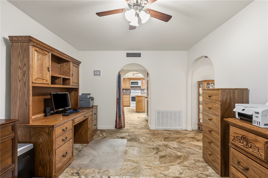 3342 Park Ridge Avenue Bullhead City, AZ 86429 - Photo 45 of 93 This area features white walls, a ceiling fan with light fixture, and stone tile flooring
