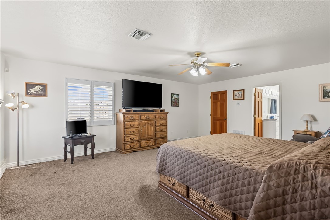 3342 Park Ridge Avenue Bullhead City, AZ 86429 - Photo 47 of 93 This spacious room features carpeted flooring, a ceiling fan, and a window with plantation shutters