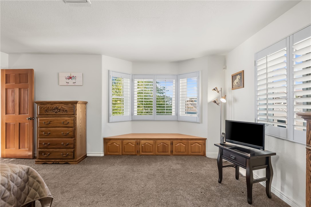 3342 Park Ridge Avenue Bullhead City, AZ 86429 - Photo 48 of 93 This room features a bay window with white plantation shutters and an integrated storage bench, alongside an additional window also fitted with white plantation shutters