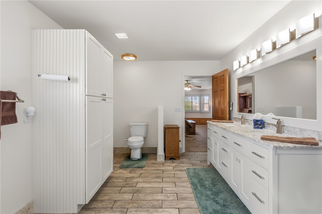 3342 Park Ridge Avenue Bullhead City, AZ 86429 - Photo 52 of 93 The bathroom features a double vanity with two sinks, a wall-mounted mirror, and white cabinetry
