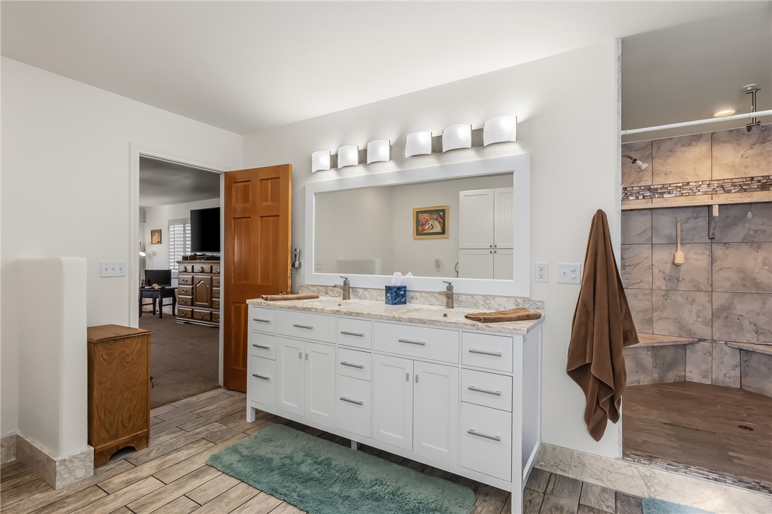3342 Park Ridge Avenue Bullhead City, AZ 86429 - Photo 53 of 93 The bathroom features a double vanity with white cabinetry, a large mirror, and overhead lighting