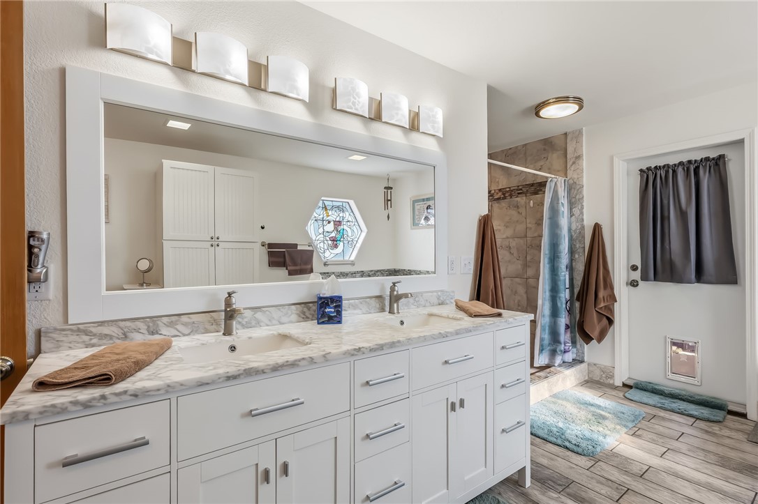 3342 Park Ridge Avenue Bullhead City, AZ 86429 - Photo 54 of 93 Bathroom featuring a double vanity with white cabinetry, a marble-patterned countertop, and a large mirror