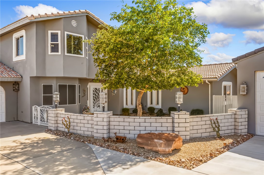 3342 Park Ridge Avenue Bullhead City, AZ 86429 - Photo 6 of 93 The property features a stucco exterior, a tiled roof, and a decorative white brick wall with matching pillars