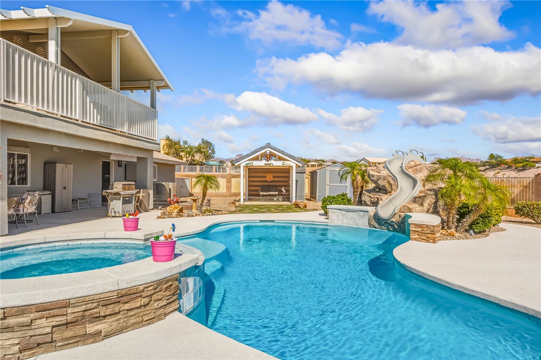 3342 Park Ridge Avenue Bullhead City, AZ 86429 - Photo 64 of 93 The property features an expansive swimming pool with an integrated spa, complete with a rock-themed slide